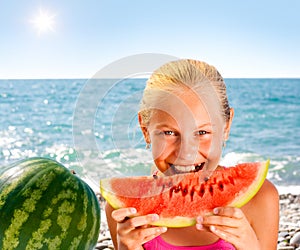 Girl eating watermelon on seashore or beach