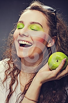 Girl eats a juicy apple