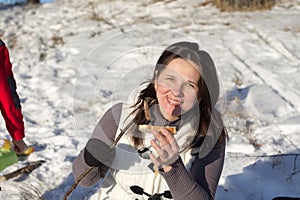 Girl eats kebab outdoors in winter