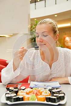 Girl eats sushi