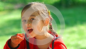 Girl eats tomato photo