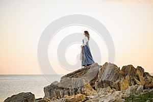 Girl on the edge of a cliff looking out to sea