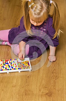 Girl with educational pin puzzle toy