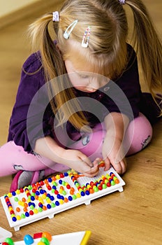 Girl with educational pin puzzle toy