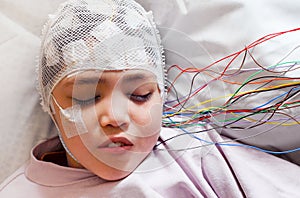 Girl with EEG electrodes attached to her head for medical test photo