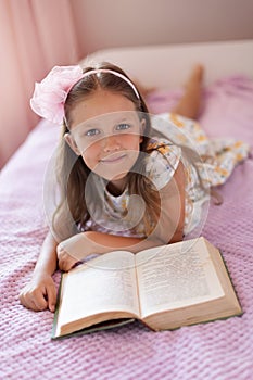 A girl of eight years reads a book