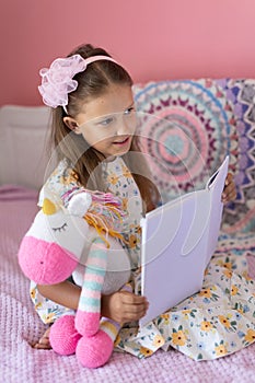 A girl of eight years reads a book