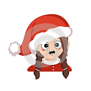 Girl with emotions panic, surprised face, shocked eyes in red Santa hat