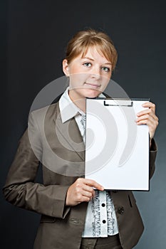 Girl with an empty plate on a black background