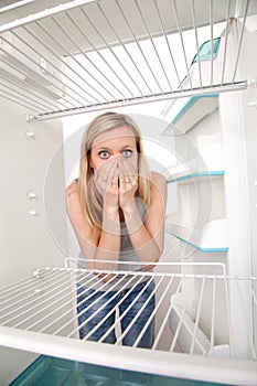 Girl and empty refrigerator