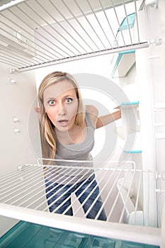 Girl and empty refrigerator