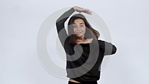 Girl energetically dances in the studio