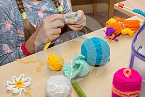 The girl is engaged in needlework in the classroom