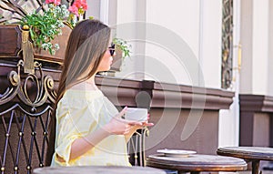 Girl enjoy morning coffee. Waiting for date. Woman in sunglasses drink coffee outdoors. Girl relax in cafe cappuccino