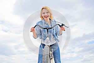 Girl enjoy short cycle tour with stop offs along way and travel. Girl holds handlebar of bike. Woman likes to ride bike