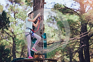 Girl enjoying activity in a climbing adventure park