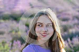 Girl enjoying blooming lavender field. cheerful girl in lavender flowers field. teen girl holding a lavender bouquet of