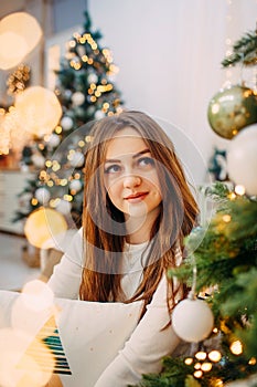 Girl enjoying Christmas cozy atmosphere and dreaming about future