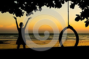 Girl is enjoying the freedom at sunset beach.