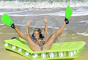 Girl enjoying on an inflatable beach mattress