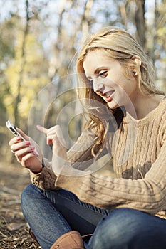 Girl enjoying internet wireless on smartphone in n