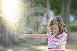 Girl enjoying the light summer rain.