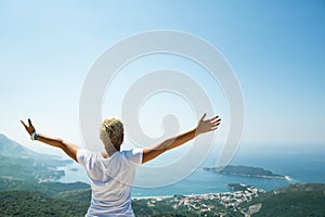 Girl enjoying in nature with raised up hands