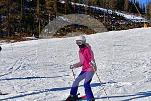 Girl learning to ski on the snow on the hill