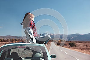 Girl enjoying road trip