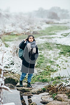 Girl enjoying the view of the frozen lake or river.