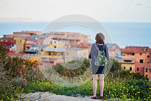 Girl enjoying view to Castelsardo village in Sardinia, Italy