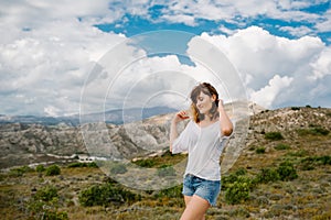 A girl enjoys a beautiful landscape with mountain views on the island of Rhodes