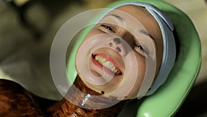 A girl enjoys a chocolate massage in the spa. close-up