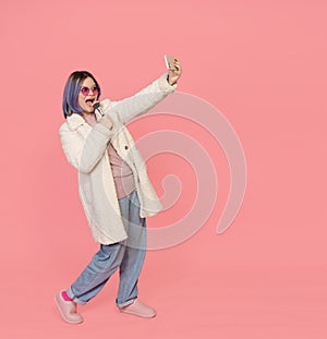 Girl Enjoys Karaoke With Make-Up Brush As Microphone In Selfie Camera Of Mobile Phone. The Image Radiates Positivity And
