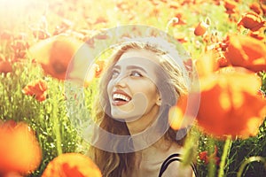 Girl enjoys life. fashion portrait of a sensual girl. poppy seed and happy girl with long curly hair