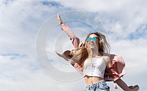 Girl enjoys listening to music jumping for joy in a park
