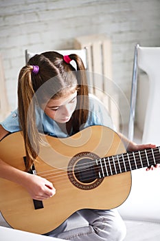 Girl enjoys playing the guitar