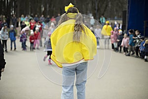 Girl entertains children in square. City holiday in park