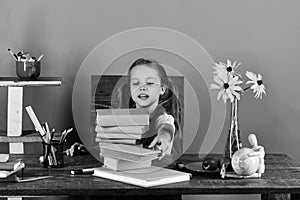 Girl with enthusiastic face takes book. Back to school