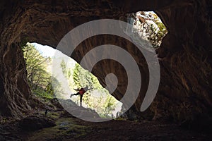 Girl in the entrance of a cave