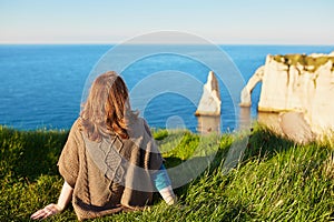 Girl in Etretat, sitting on top of hill