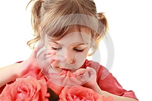 Girl examines and touches petals of rose photo