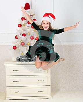 Girl excited about christmas jump mid air. Child emotional cant stop her feelings. Celebrate christmas concept. Girl in