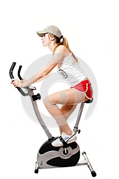 The girl on exercise bicycle