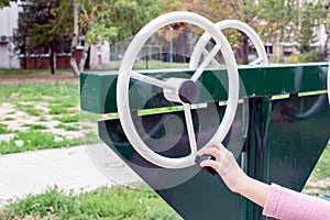 Girl exercising at outdoors gym playground equipment