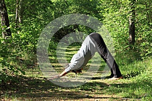 Girl exercising yoga pose downward dog