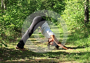 Girl exercising yoga pose downward dog