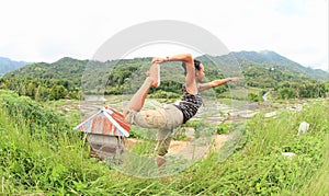 Girl exercising yoga on rice fields in mountains on Flores