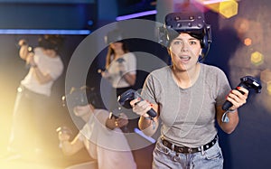 girl is exhilarated by turn of events in VR game and moved virtual reality glasses to forehead