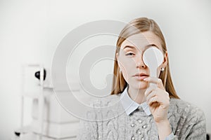 Girl experiences eye problems reception doctor ophthalmologist.